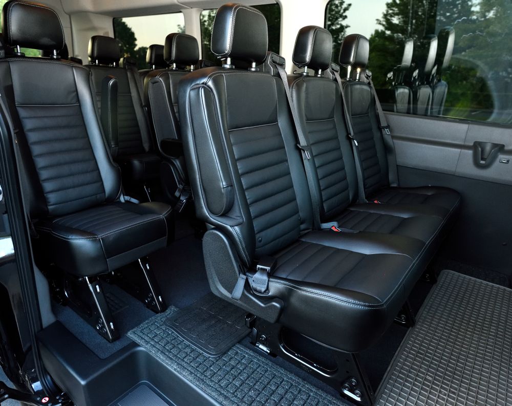 Premium van interior with black leather seating for corporate group travel