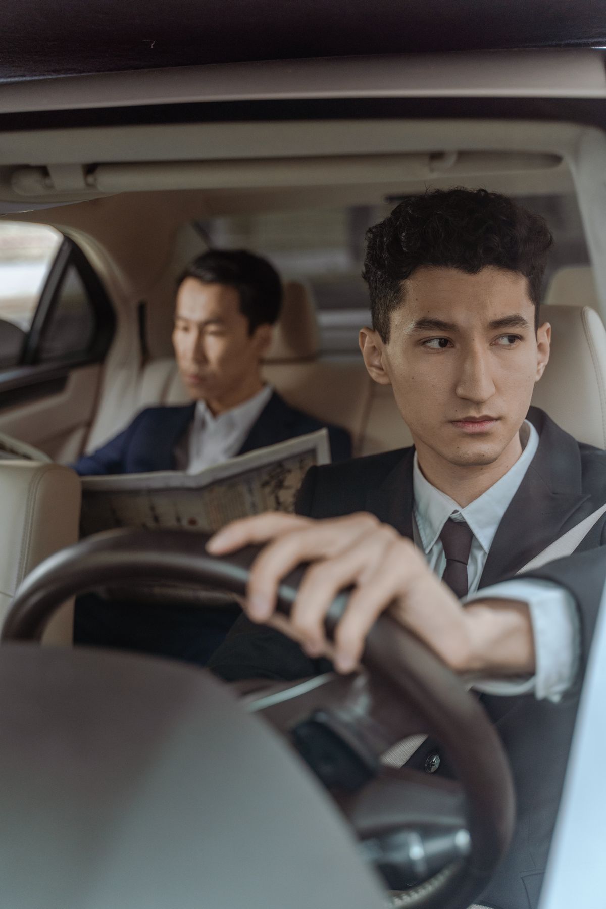 Uniformed chauffeur driving a corporate passenger